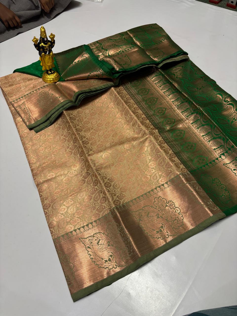 Antique gold silk saree with bottle green zari border