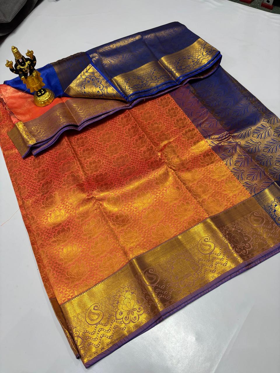 Dual-tone orange and pink Elampillai saree with royal blue floral zari border.