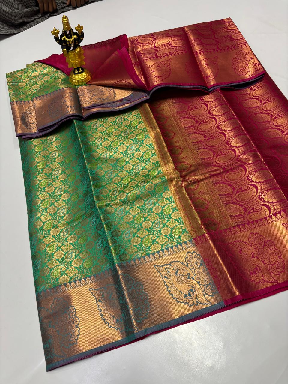 Dual tone green Elampillai saree with maroon border and heavy paisley copper zari work.