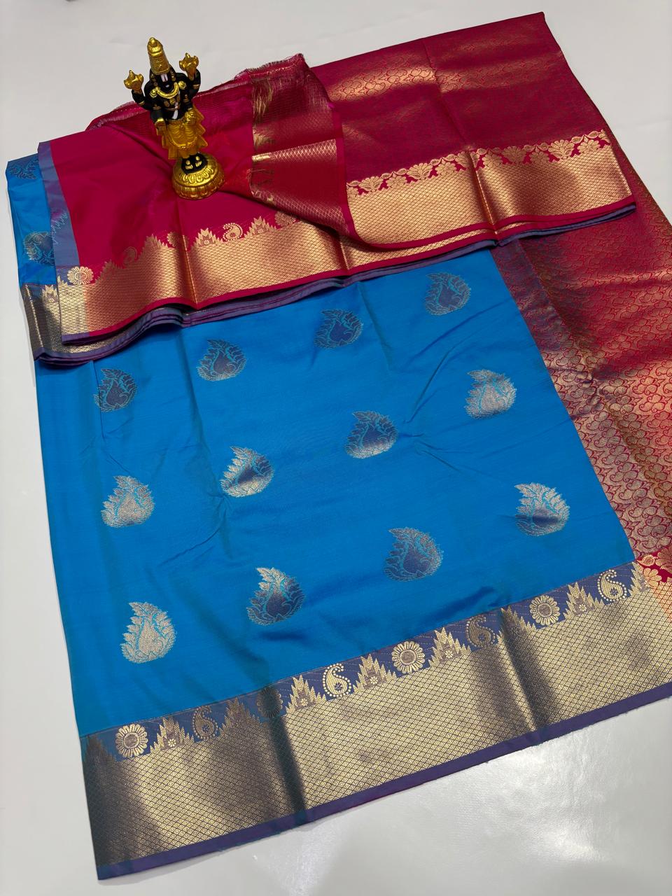 Electric Blue Elampillai saree with mango motifs and magenta zari border.