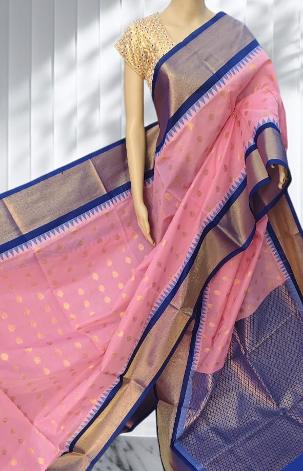 Baby pink Elampillai saree with navy blue zari border and gold buttas.