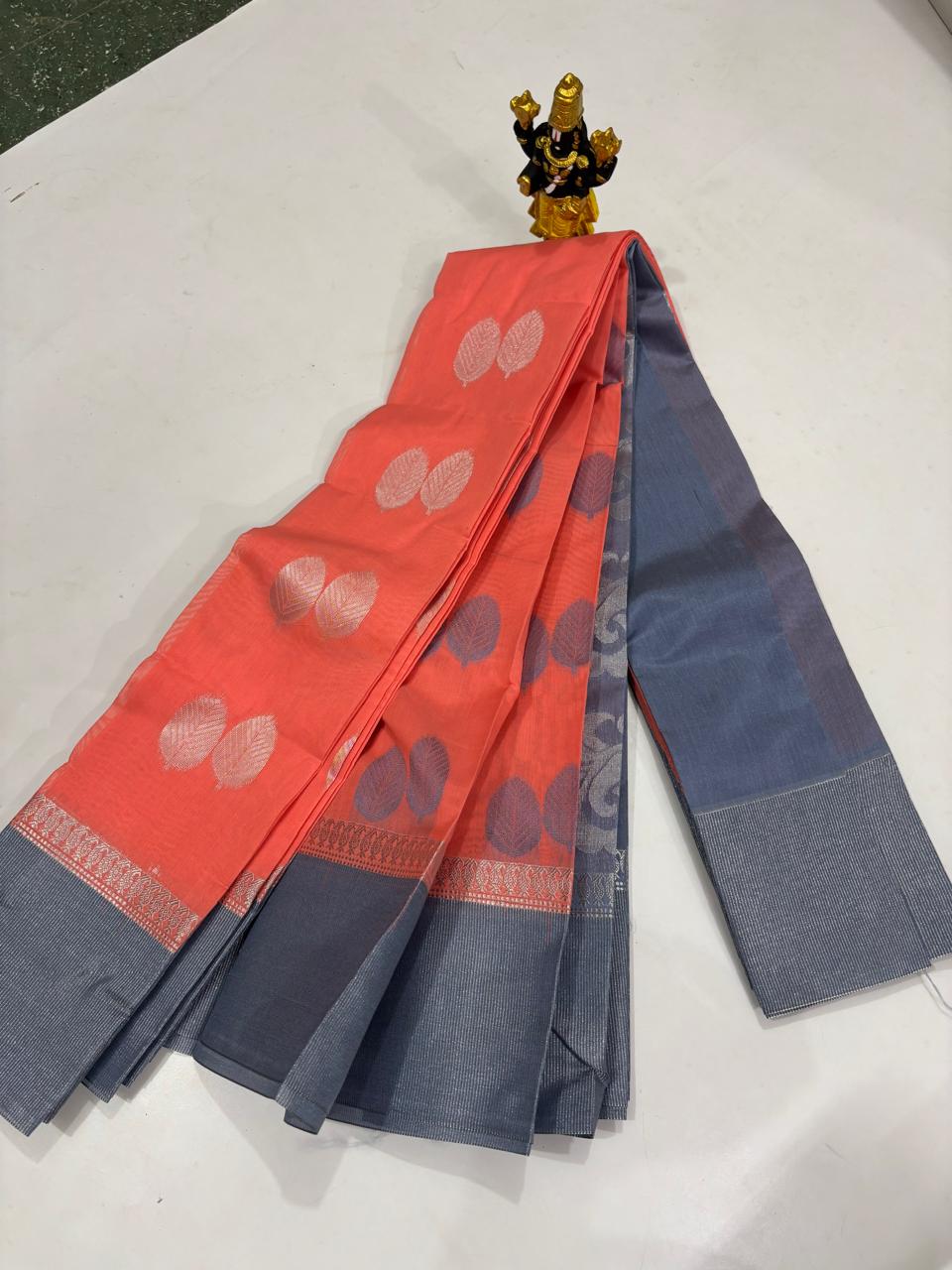 Coral peach Elampillai silk cotton saree with grey border and silver zari leaf motifs
