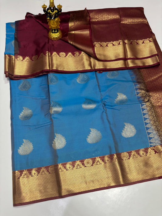 Cerulean Blue Elampillai saree with paisley buttas and deep maroon border.