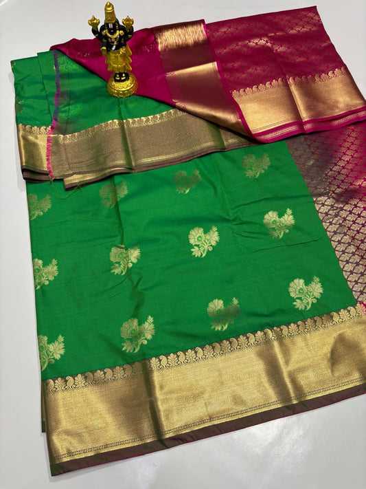 Emerald Green Elampillai saree with gold floral motifs and fuchsia pink zari border.