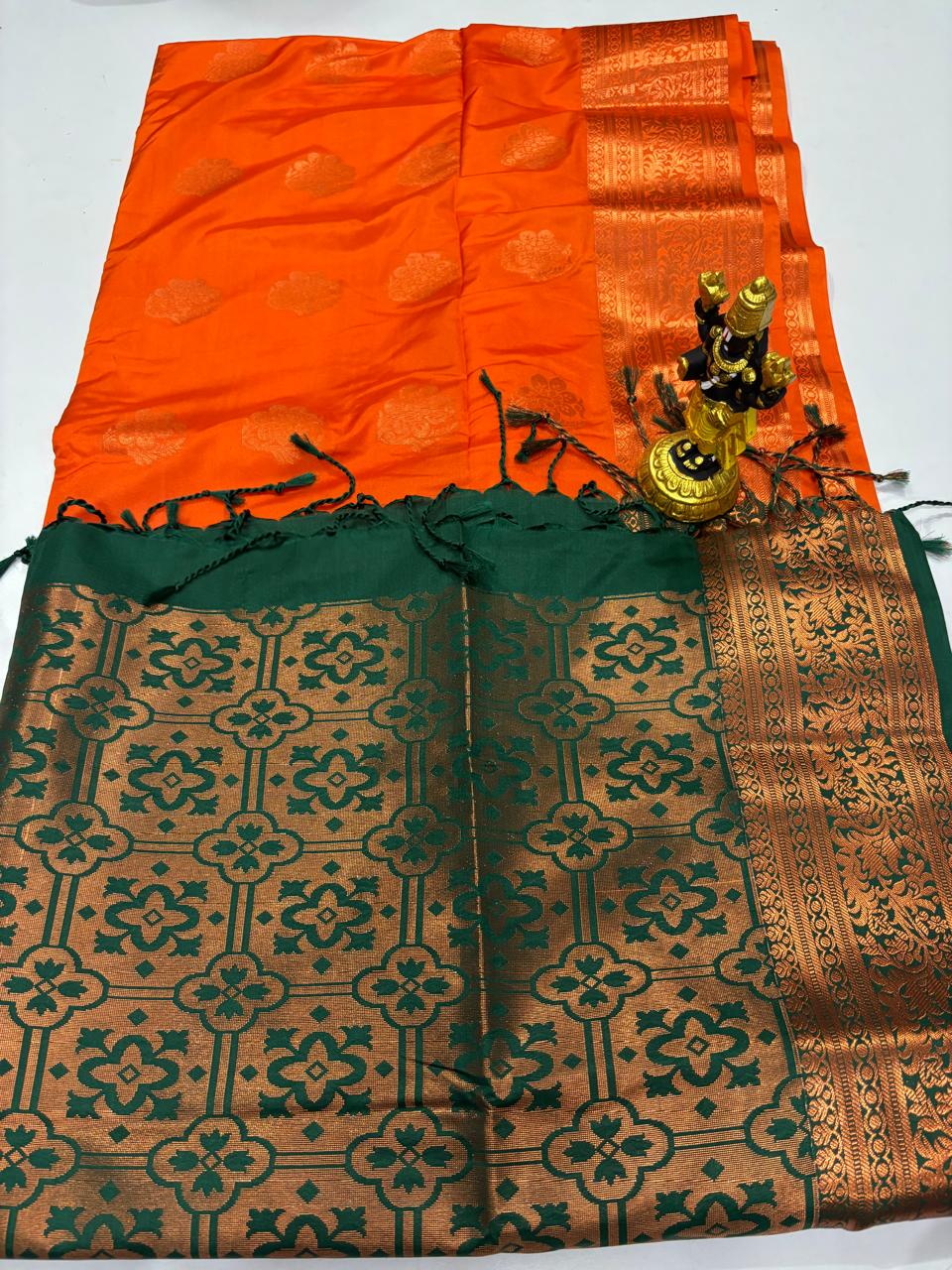 Tangerine Elampillai silk saree with forest green lattice zari pallu.