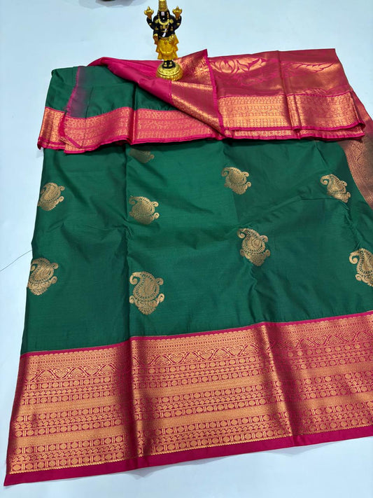 Bottle green Elampillai silk saree with magenta pink border and gold paisley buttas.