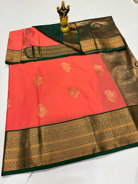 Coral peach Elampillai silk saree with dark green border and mango buttas.