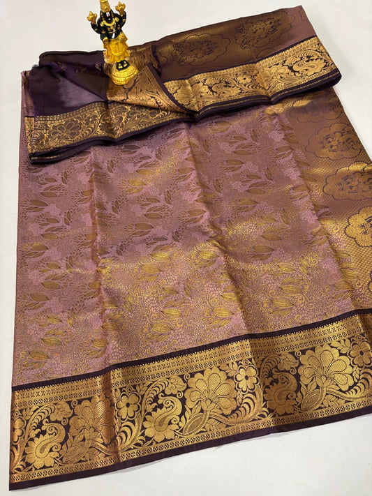 Dusty rose silk saree with gold leaf patterns and a purple peacock Zari border.