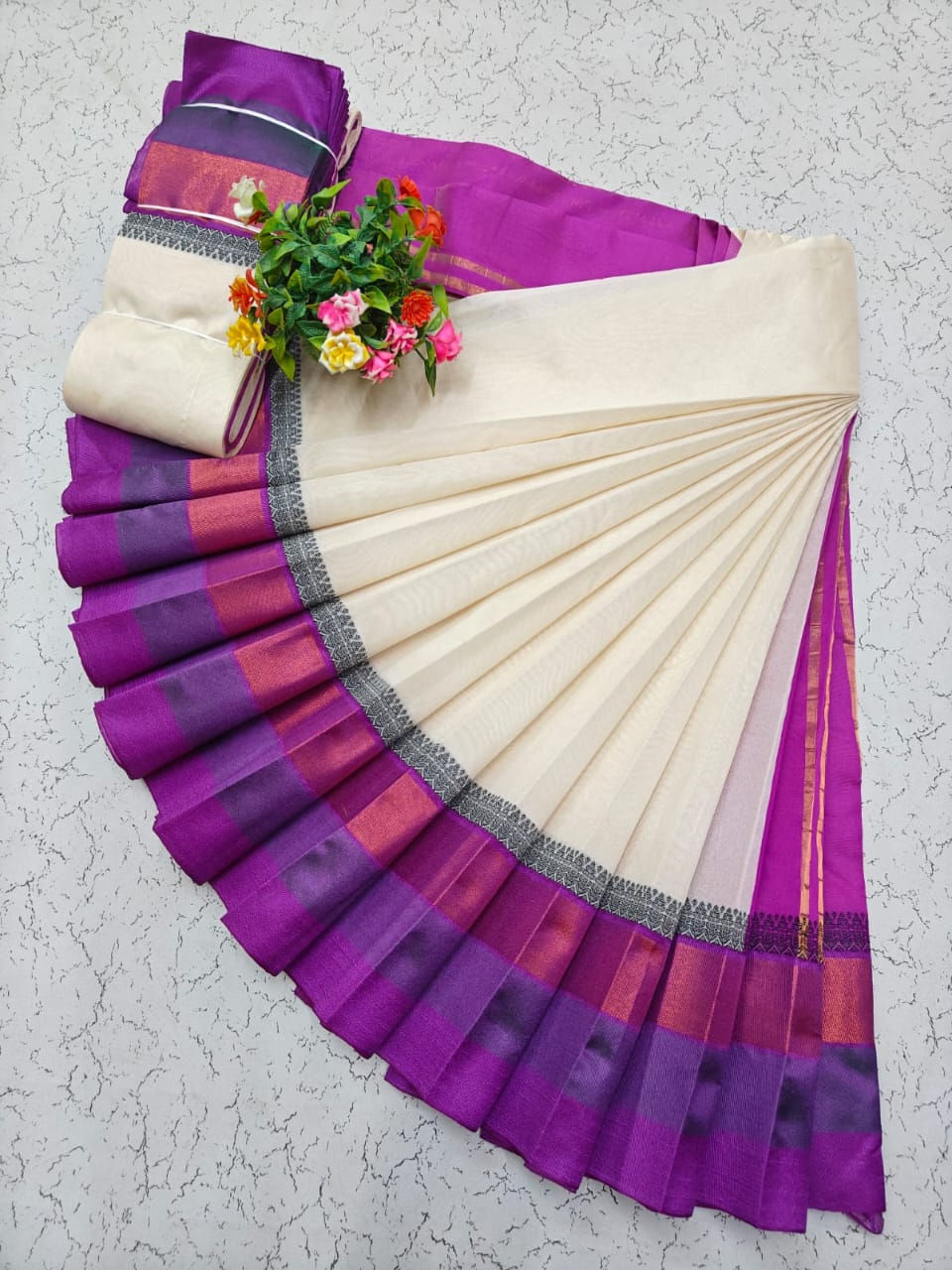 Cream Elampillai saree with a magenta and copper zari border featuring black accents.