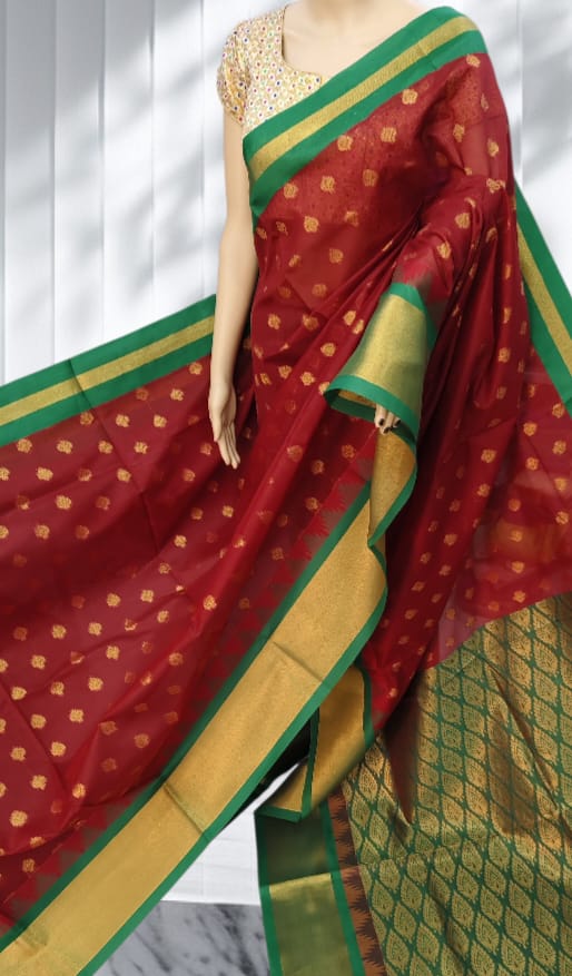 Deep maroon Elampillai saree with emerald green zari border and gold motifs.