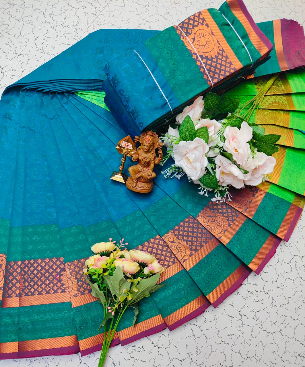 Blue green saree with copper zari border and woven texture