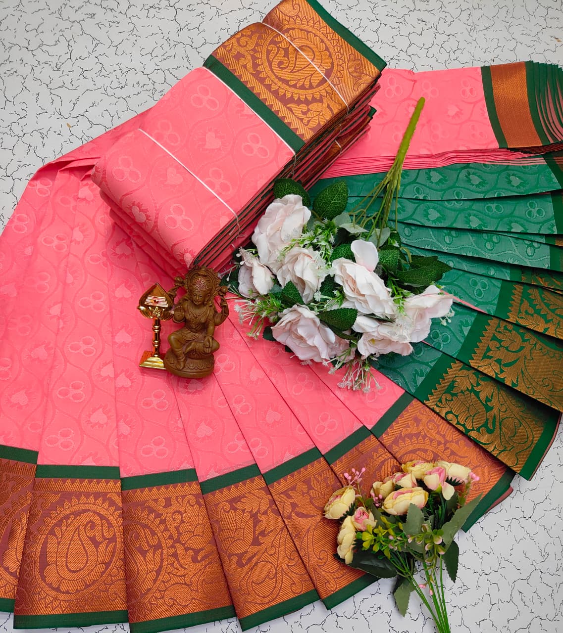 Coral pink woven saree with green and gold zari border